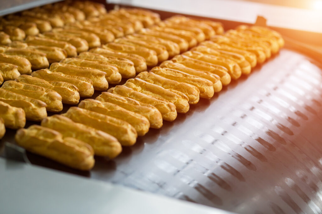 Eclair shells on conveyor line.