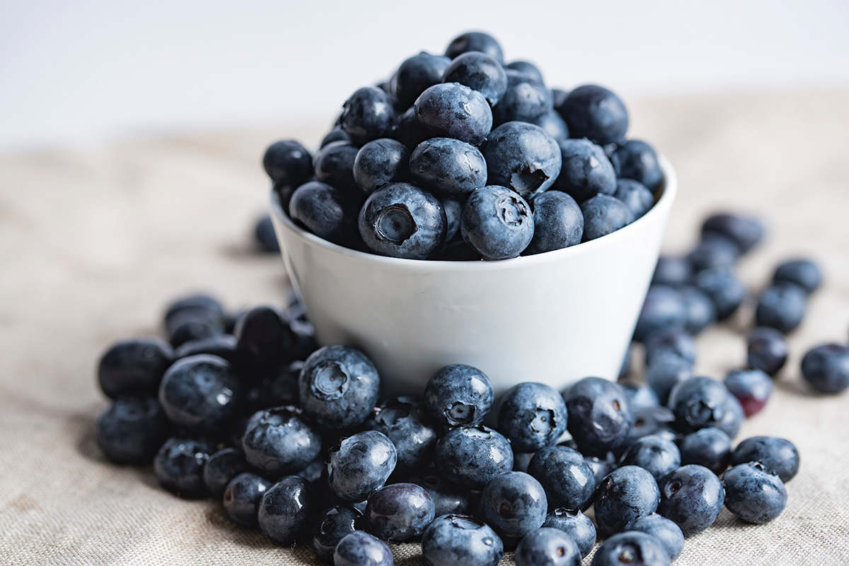 an overflowing cup of blueberries